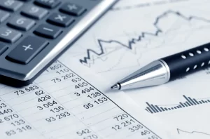 Scaling-up | Pen and calculator on desk with financial data written on some paper.