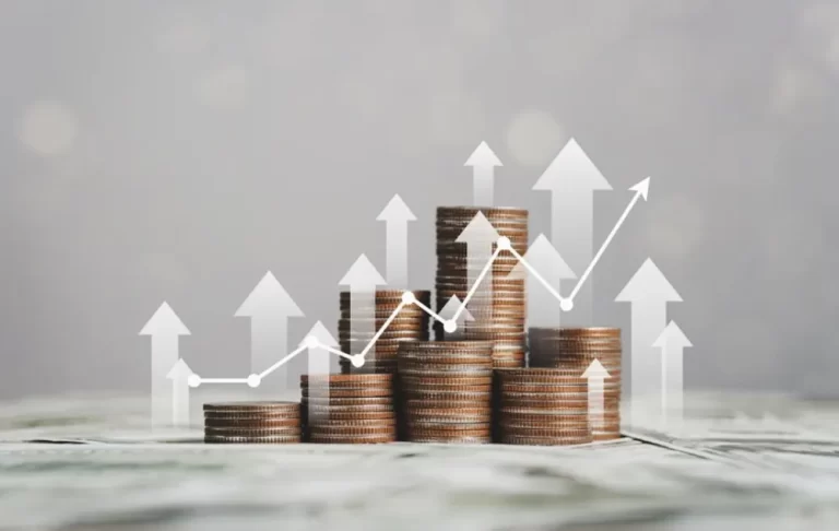 financial management | Stacks of coins with a graph overlayed to show growth.