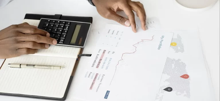 sole trader vs limited company | person filling in financial documents.