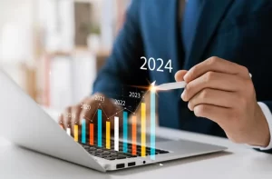 Financial risk management | Person pointing at a holographic bar chart with the number 2024 at the top.