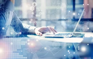Financial Management Course | Person typing on laptop with financial graphics overlaid.
