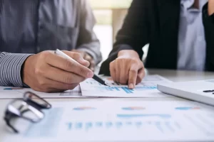 Financial planning | People looking over financial documents.