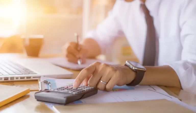 Accountants in Buckinghamshire | Person typing on calculator.