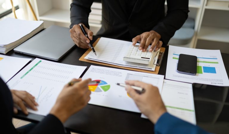 Two people looking at graphs and tables